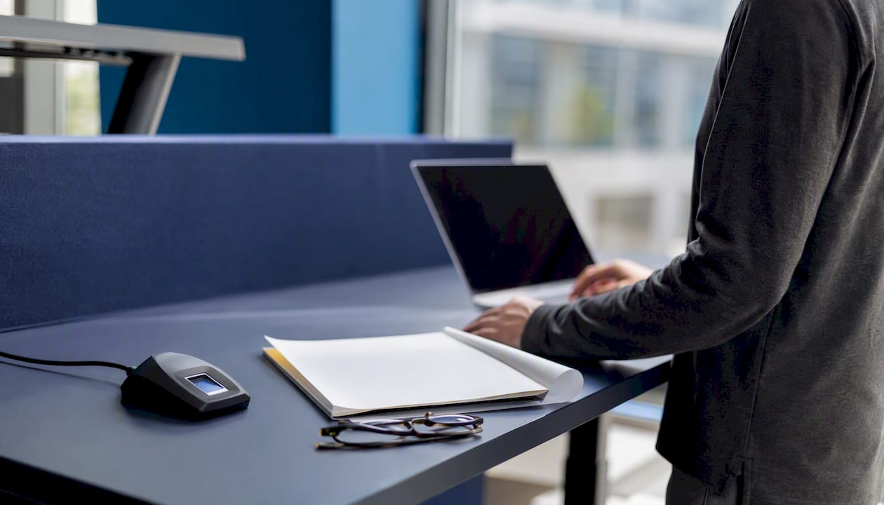 Workspace with fingerprint scanner and blank documents